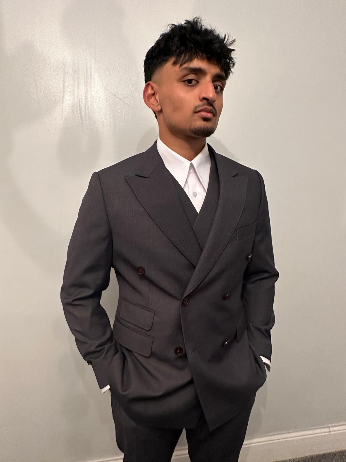 Groom in a light grey three-piece wedding suit